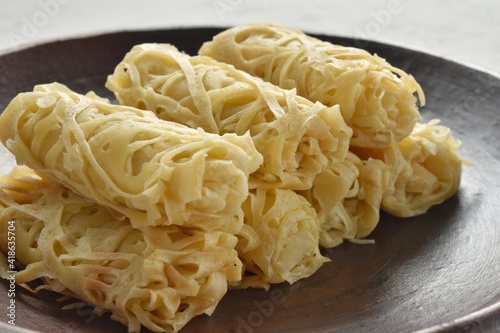 Roti Jala or lace pancake is Malaysian traditional food photo