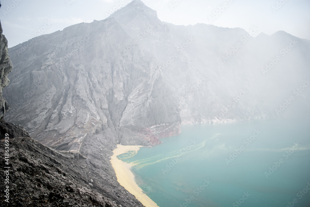The sulfuric lake of Kawah Ijen vulcano in East Java, Indonesia from Dutch Heritage Ijen Dam.