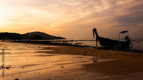 small fishing boat on the beach in the evening