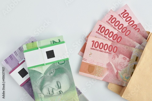 Indonesian money, rupiah/IDR isolated on white background. Closely to eid mubarak day, usually all moslems employee received THR or Eid Mubarak bonuses. photo