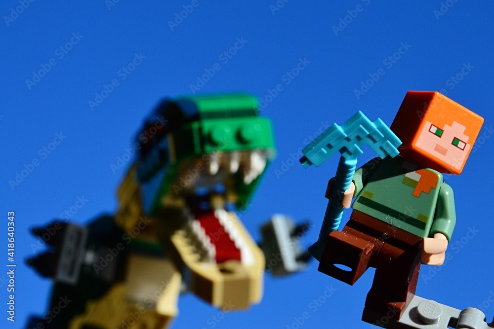 LEGO Minecraft figure of Alex running from angry Tyrannosaurus Rex from LEGO  Creator series, holding diamond pickaxe in left hand. Stock Photo | Adobe  Stock