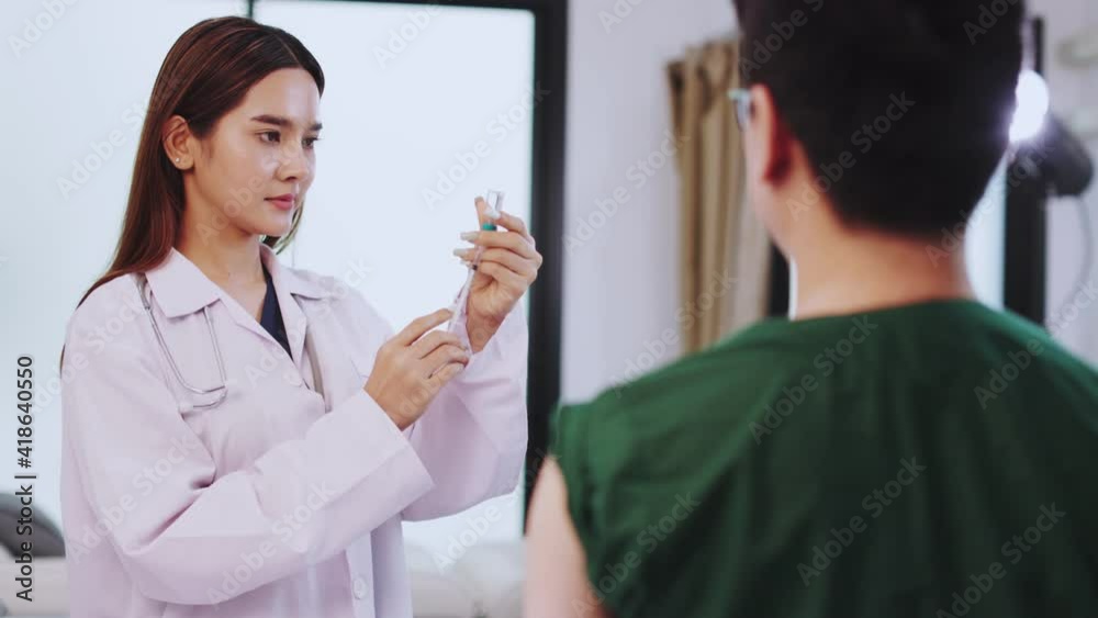 Female doctor talking to patient.doctor with syringe doing injection of vaccine to female patient . Medicine and health care concept. Protect corona virus ,covid19 Female doctor talking to patient.doctor with syringe doing injection of vaccine to female patient . Medicine and health care concept. Protect corona virus ,covid19
