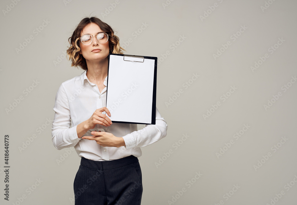 Business woman in a shirt holds a folder with a white sheet of paper Copy Space Business woman in a shirt holds a folder with a white sheet of paper Copy Space