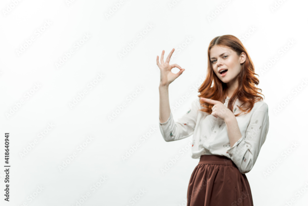 pretty woman with red hair in suit gesturing with hands studio pretty woman with red hair in suit gesturing with hands studio