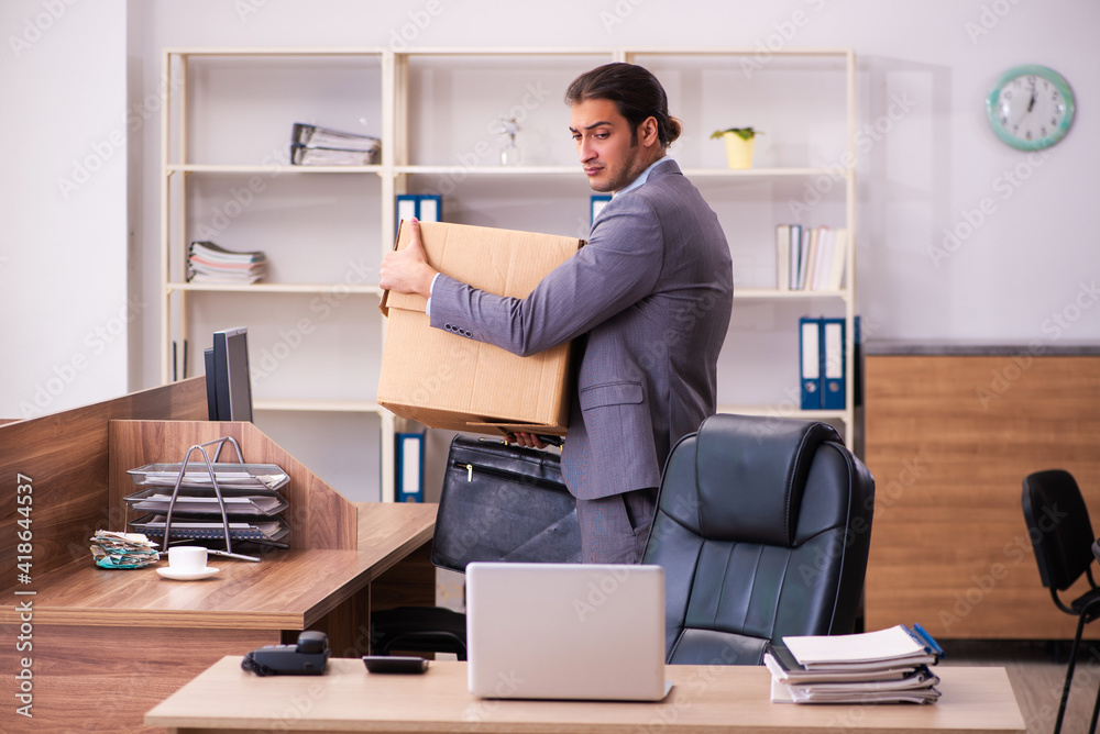 Young male employee being dismissed from his work Young male employee being dismissed from his work