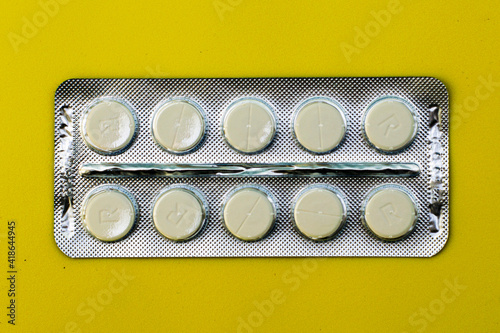 blister with tablets on a yellow background