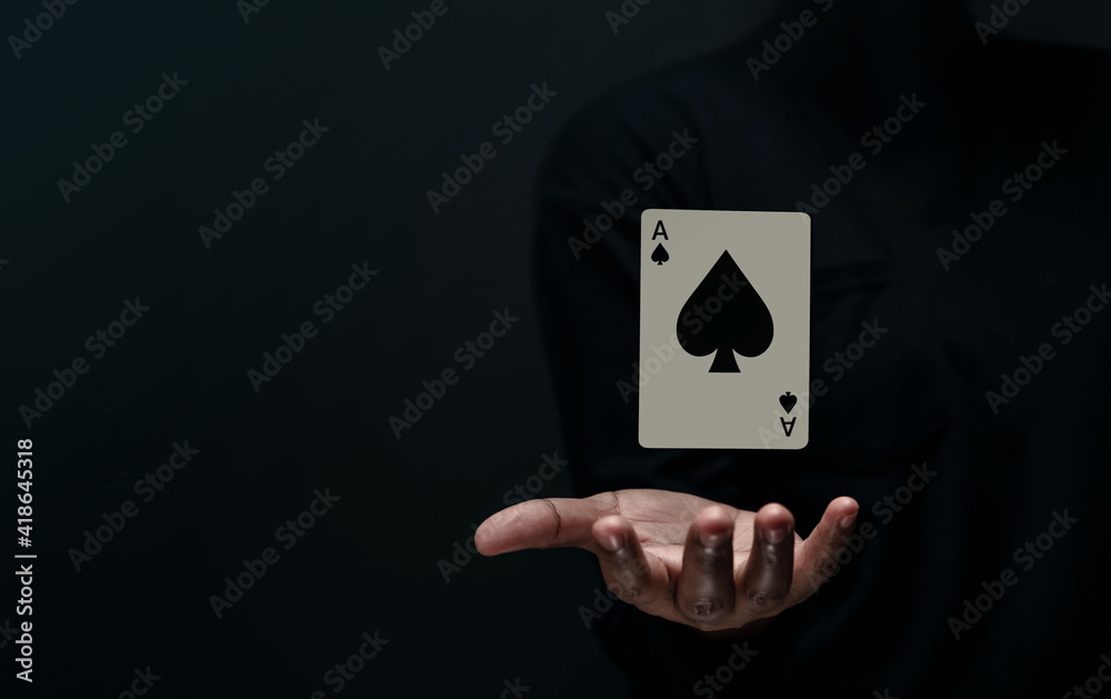 Ace Spade Playing Card. Levitating Poker Card on Hand. Front View. Closeup and Dark Tone Ace Spade Playing Card. Levitating Poker Card on Hand. Front View. Closeup and Dark Tone