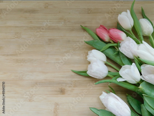 Tulips flowers on a wooden rustic table. Spring holidays concept background.