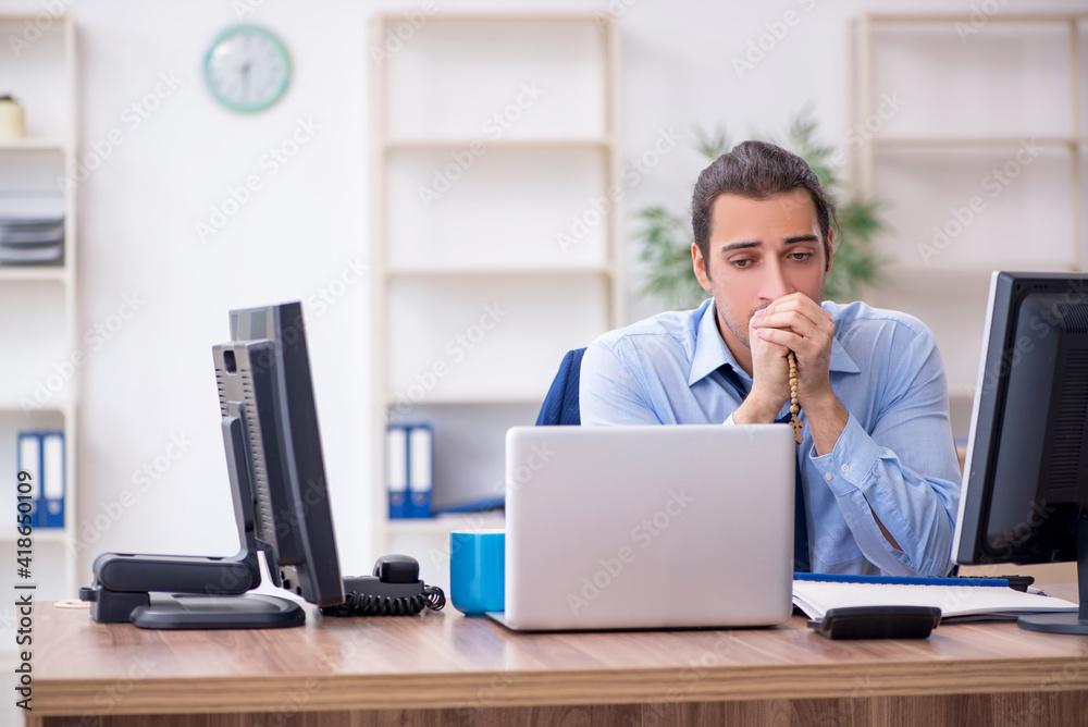 Young male employee unhappy with excessive work Young male employee unhappy with excessive work
