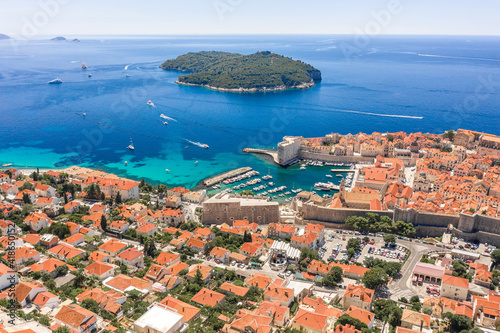 Aerial drone shot of Otok Lokrum in Adriatic sea near Dubrovnik old town in Croatia summer noon