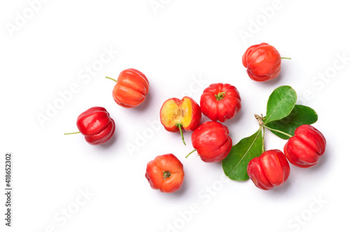 Flat lay of Acerola cherry with cut in half and leaves on white background.