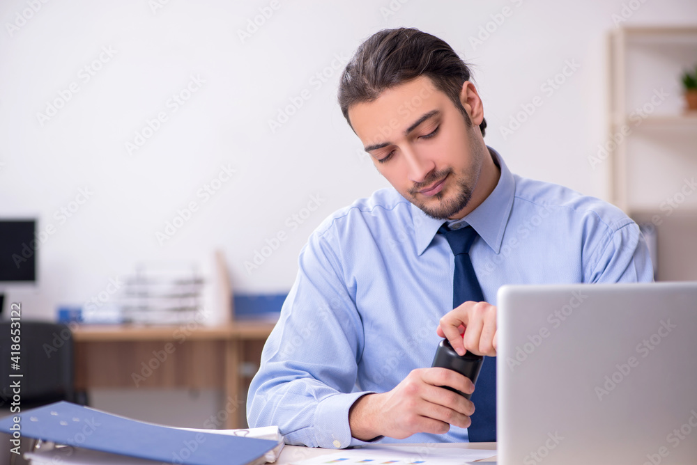 Sick male employee suffering at workplace