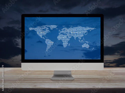 Global business words world map on desktop modern computer monitor screen on wooden table over sunset sky, Global business online concept, Elements of this image furnished by NASA