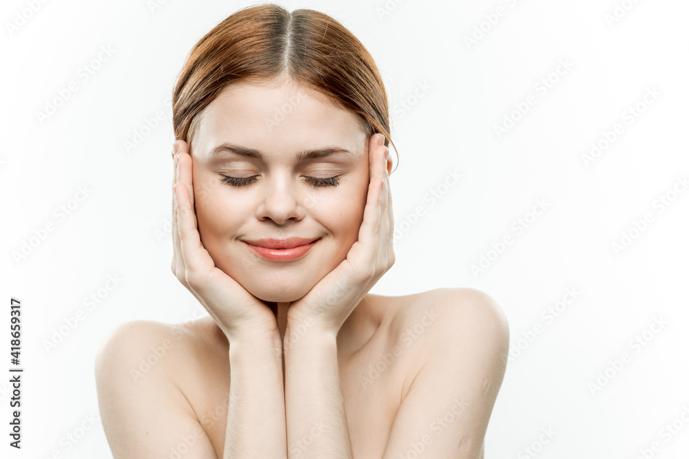 woman with closed eyes holds hands near face naked shoulders emotions light background woman with closed eyes holds hands near face naked shoulders emotions light background