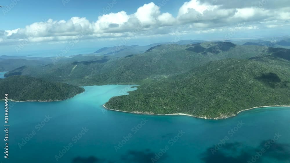 Aerial view of Whitsunday Islands archipelago from a flying airplane Aerial view of Whitsunday Islands archipelago from a flying airplane