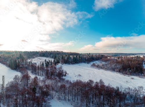 Snow-covered field and forest, panorama of winter landscape.