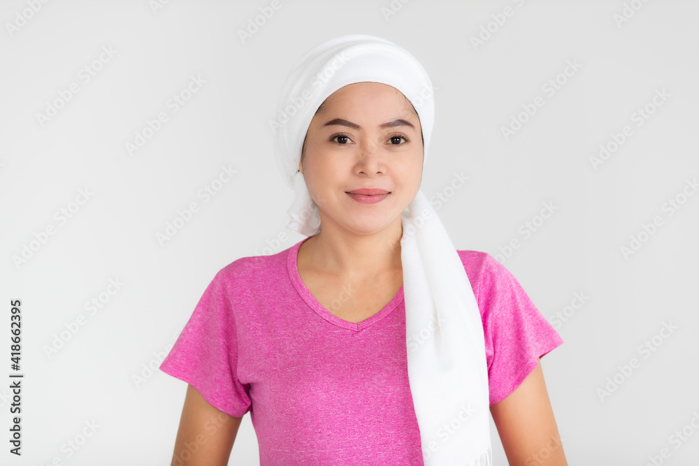 Portrait of a woman cancer patient with clothes covered around head affected from chemotherapy cure process posing with positive and self-confidence Portrait of a woman cancer patient with clothes covered around head affected from chemotherapy cure process posing with positive and self-confidence