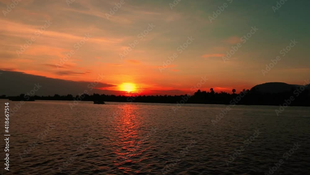 Time lapse of sunset white traditional khmer boats are heading out to sea, shows the livelihood and daily life in Cambodia Time lapse of sunset white traditional khmer boats are heading out to sea, shows the livelihood and daily life in Cambodia