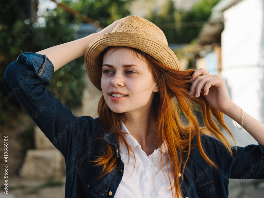 Happy woman in hat red hair shirt model countryside 
