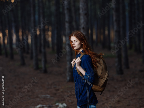 Woman Tourist with a backpack on her back walks on nature in the forest © SHOTPRIME STUDIO
