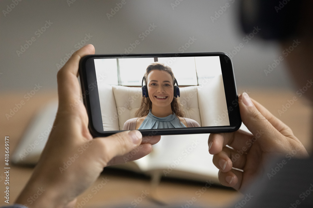 Close up of woman talk speak on video call on smartphone with smiling business partner or client. Female watch webinar on cellphone, or have online webcam lesson with tutor. Technology concept.