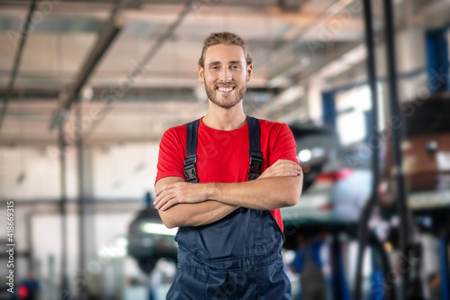 Smiling man in uniform posing in garage