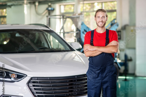 Successful repairman near car in workshop © zinkevych