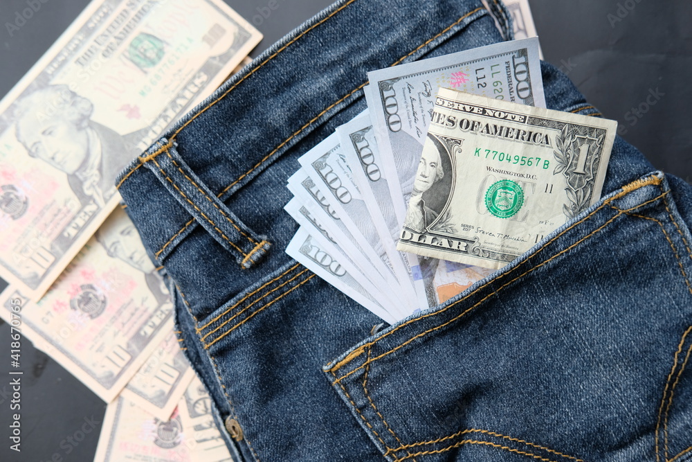 Banknote money in pocket jeans and saving money and business growth concept,finance and investment concept Banknote money in pocket jeans and saving money and business growth concept,finance and investment concept