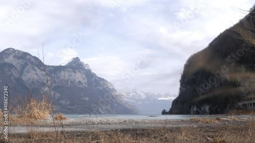 Dolly push into dry gras to reveal beautiful mountain panorama in Switzerland.