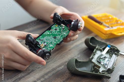 Close up of disassemble game controller repairing, cleaning or diagnostic.