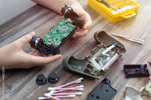 Close up of disassemble game controller repairing, cleaning or diagnostic.