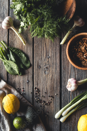 Fototapeta Naklejka Na Ścianę i Meble -  Culinary green herbs, spinach, dill, parsley, avocado in a wooden box isolated on white background