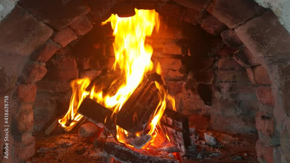 Video of wood burning fireplace. antique stone fireplace. Fire is burning in the fireplace. Hearth. Warmth and home comfort. Flames of a village house.