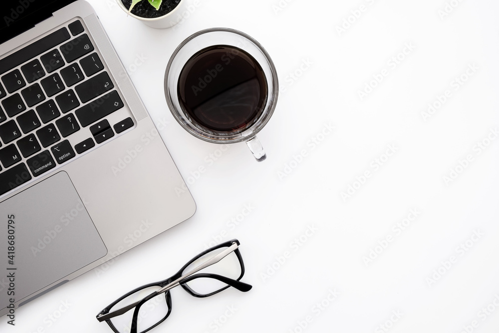 White office desk table with laptop computer, cup of coffee and supplies. Top view with copy space, flat lay. White office desk table with laptop computer, cup of coffee and supplies. Top view with copy space, flat lay.