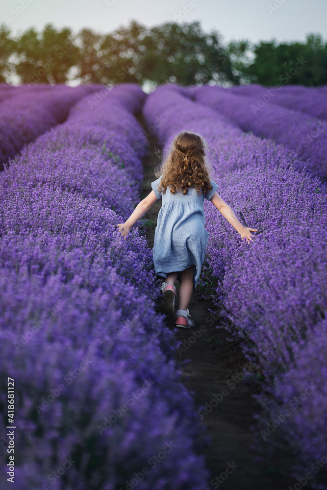 girl running across the field with lavender girl running across the field with lavender
