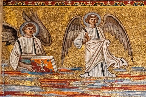 Detail of religious golden mosaic showing a scene with angels on the wall of catholic church in Rome