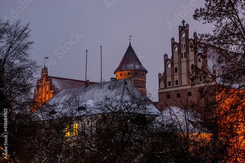 Fototapeta Naklejka Na Ścianę i Meble -  Castle of the Warmian Chapter in Olsztyn. Museum of Warmia and Mazury - in the evening at sunset in winter