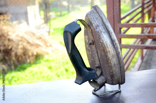 the silver black plastic mettle old electrical press on the green brown background.