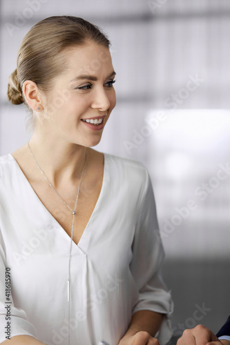 Business people discussing something while sitting in office. Focus at businesswoman while talking to her male colleague. Teamwork and meeting concept Free Download Business people discussing something while sitting in office. Focus at businesswoman while talking to her male colleague. Teamwork and meeting concept - GFXLoad