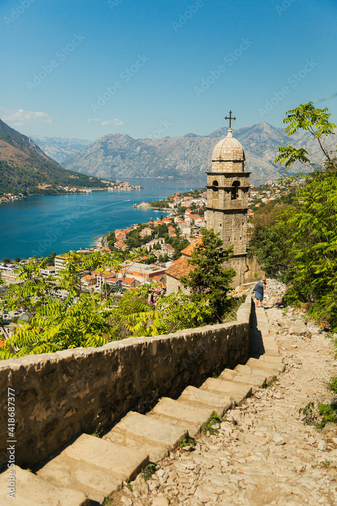 View on Church, ancient walls, mountains and sea in Kotor old town. Montenegro, Kotor bay