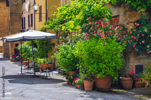 Cozy small street cafe with flowery decoration in Tuscany, Italy