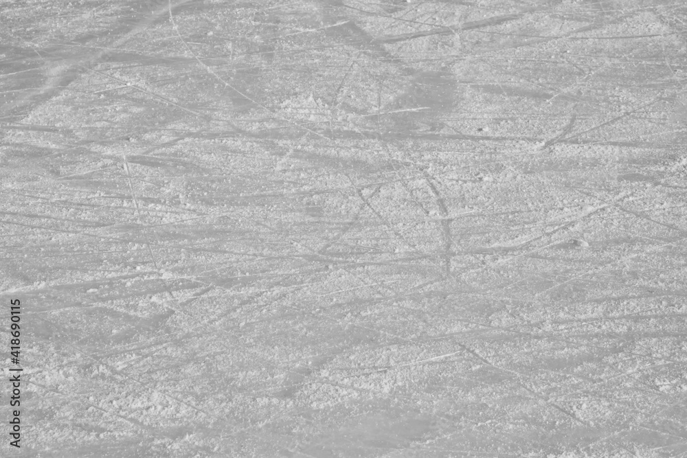 Naklejka premium Surface of an outdoor ice rink replete with skate marks