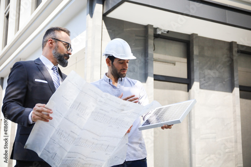 Business team people meeting and talking with engineer and architecture about planning and drawing of building construction project, smart executive professional working at outdoor