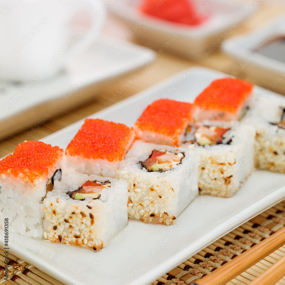 Non-classic california roll with salmon and flying fish roe Non-classic california roll with salmon and flying fish roe