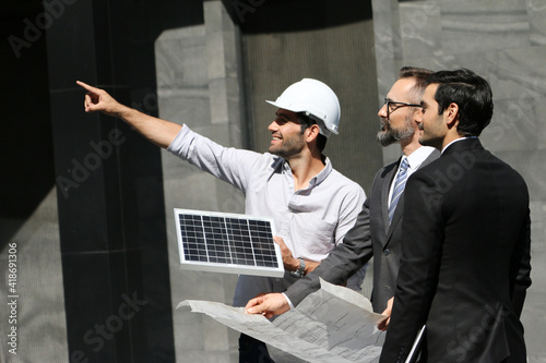Business team people meeting and talking with engineer and architecture about planning and drawing of building construction or solar cell project, smart executive professional working at outdoor