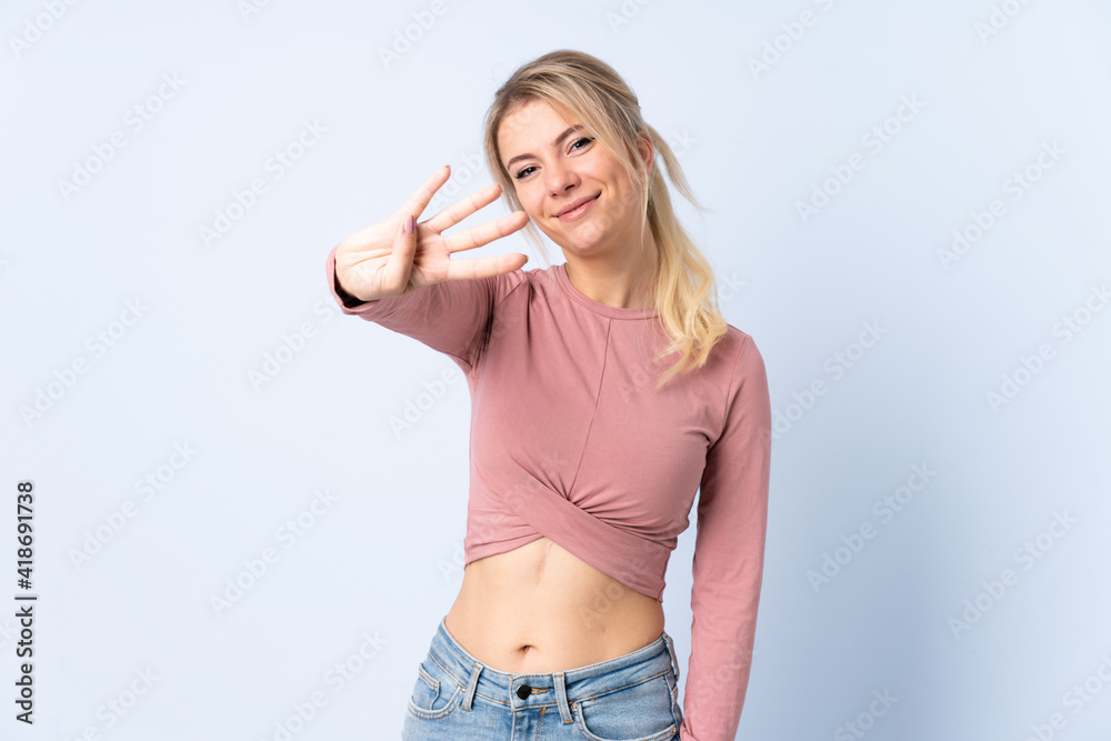 Blonde woman over isolated blue background happy and counting four with fingers Blonde woman over isolated blue background happy and counting four with fingers