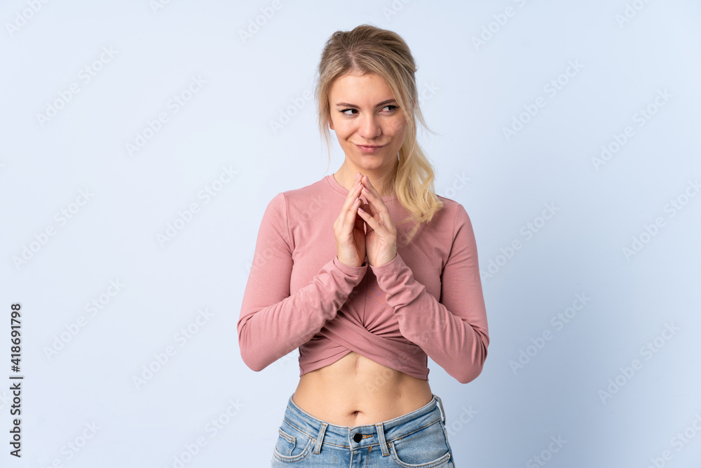 Blonde woman over isolated blue background scheming something Blonde woman over isolated blue background scheming something