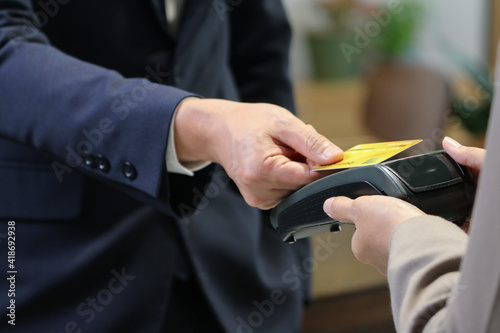 Businessman using credit card for purchase and payment something service by electronic machine internet banking reader