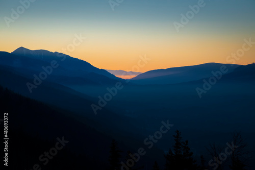 Orange sky over Podhale region  Poland. Shadow areas emphasizing the silhouette of Tatra Mountains. Selective focus on the hills  blurred background.