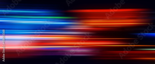 Abstract Rainbow light trails on the dark background